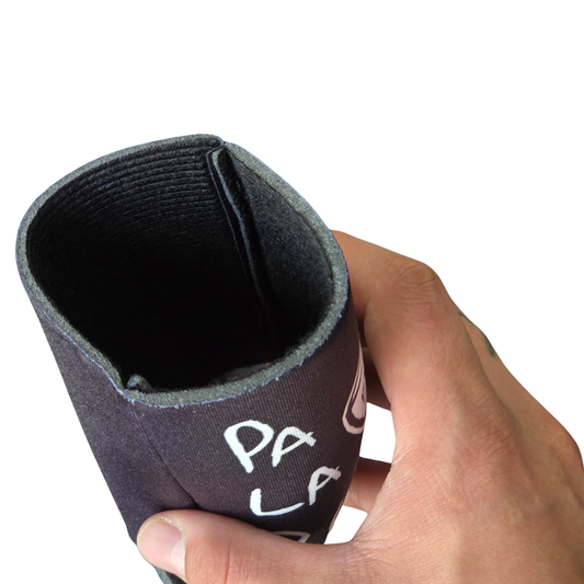 Hand holding a can cooler with 'PA LA PEDA' branding on a white background