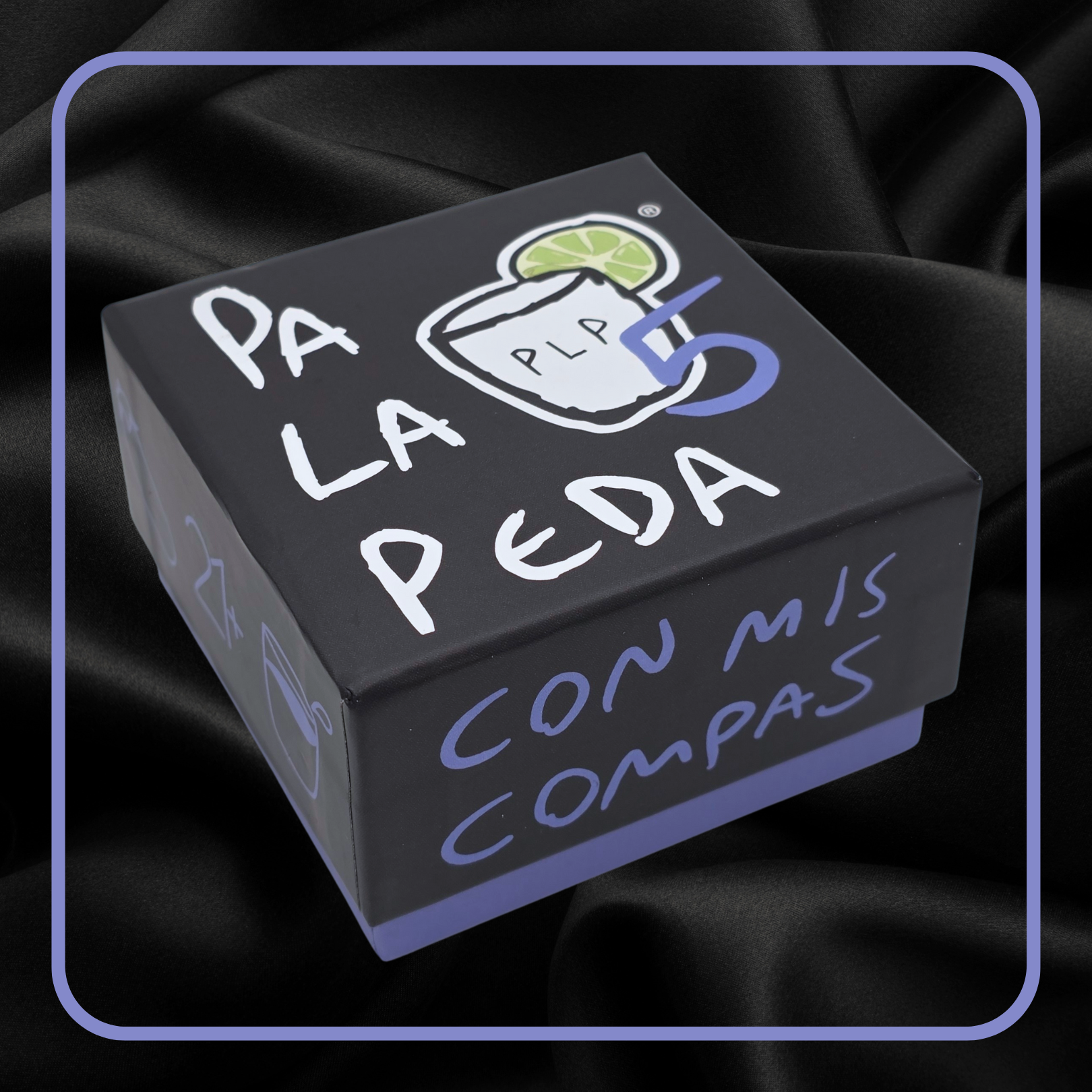 Black box with 'Pa La Peda' text and graphics on a dark fabric background