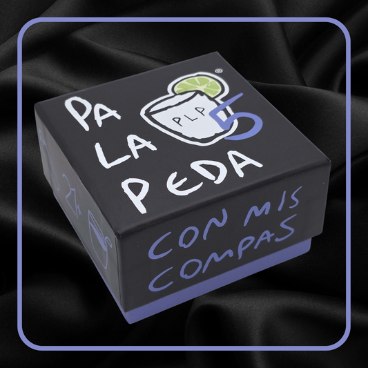 Black box with 'Pa La Peda' text and graphics on a dark fabric background