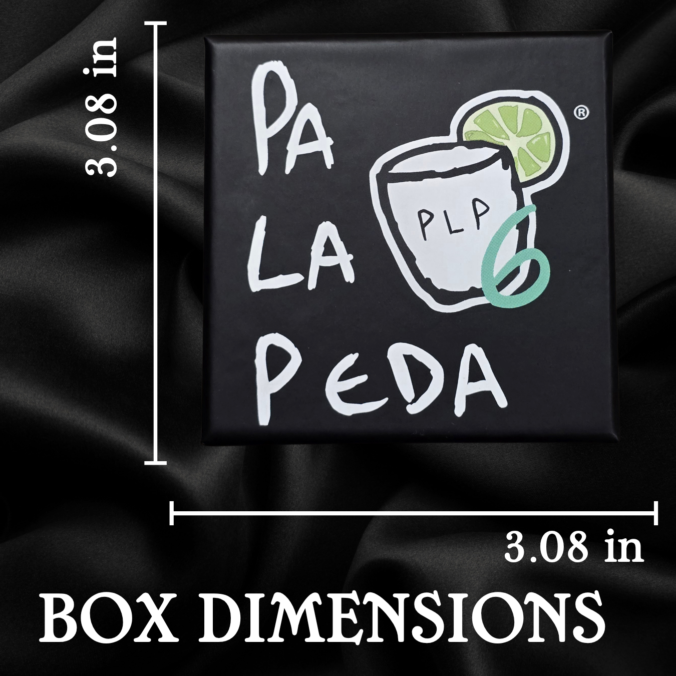 Black box with 'Pa La Peda' branding and dimensions on a dark fabric background