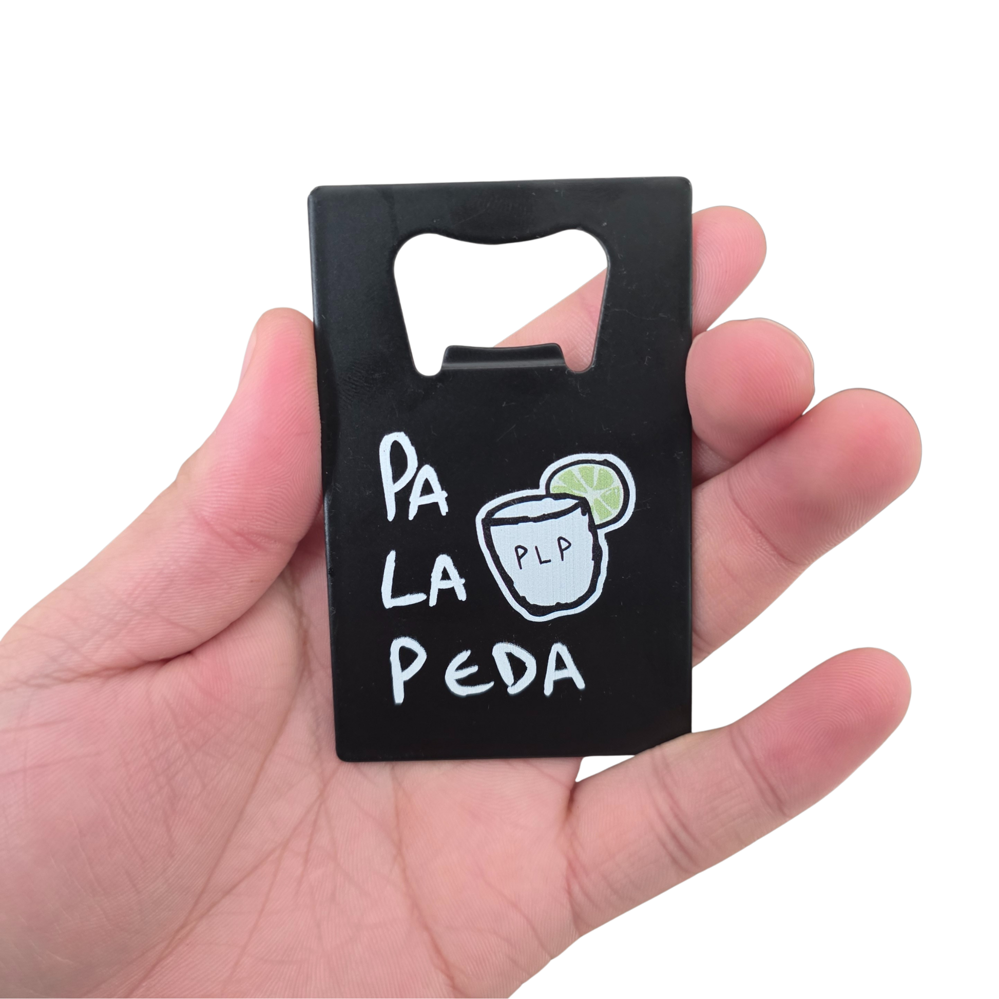 Black bottle opener with 'Pa La Peda' branding held in a hand against a white background