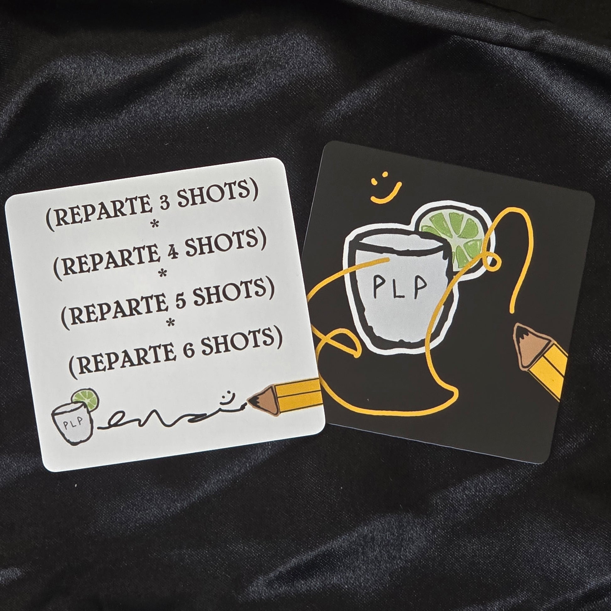 Two cards with text and graphics on a black fabric background