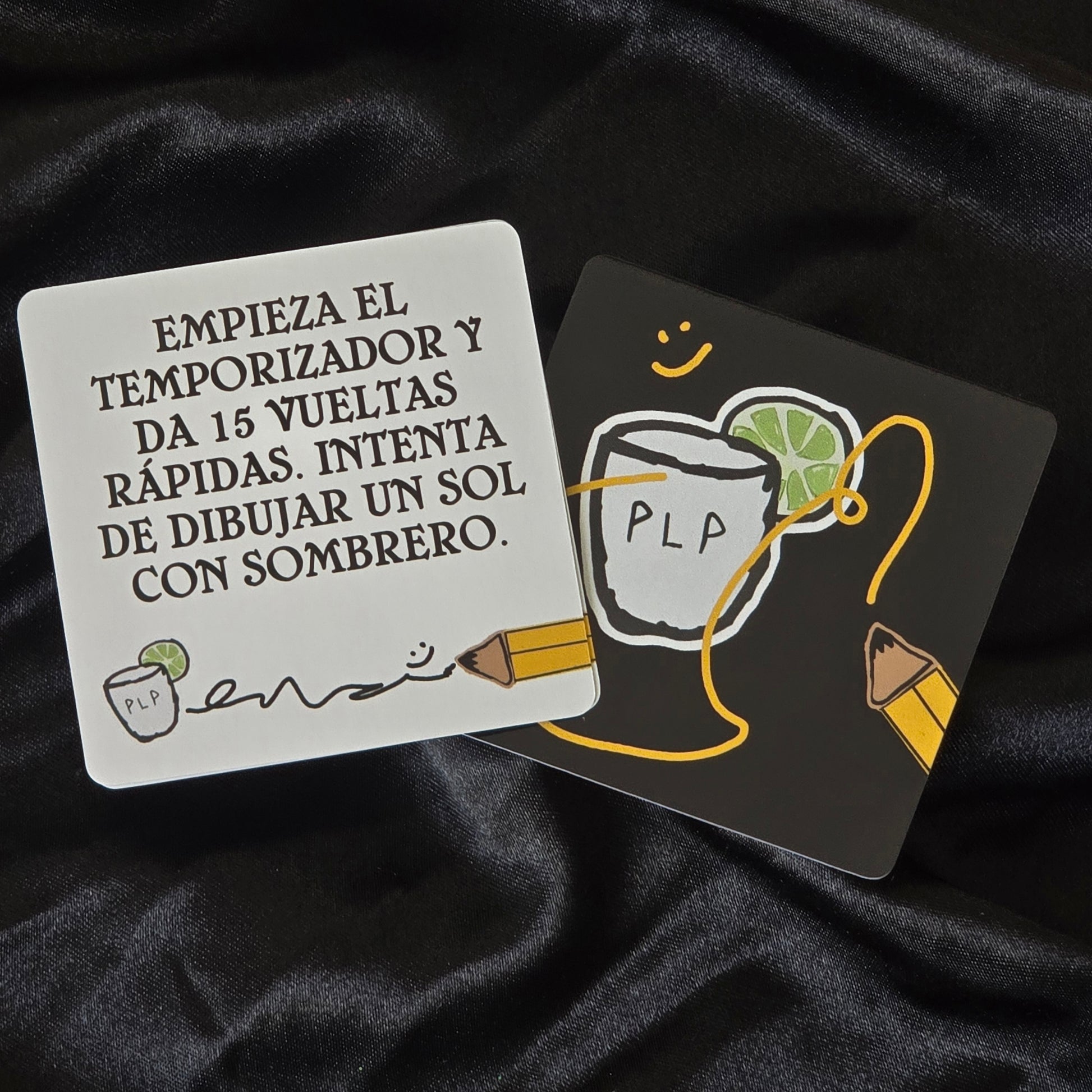 Two cards with text and illustrations on a dark fabric background