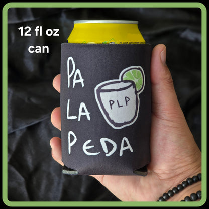 Hand holding a can cooler with 'Pa La Peda' branding against a dark background