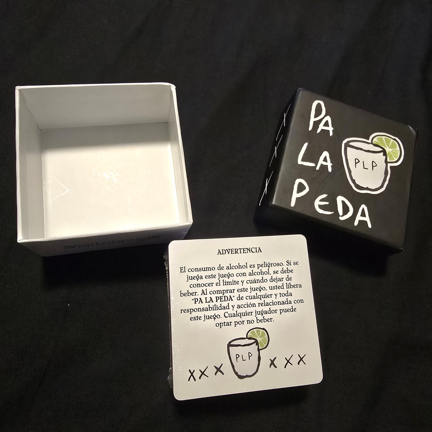 Playing cards with 'PA LA PEDA' branding on a black background