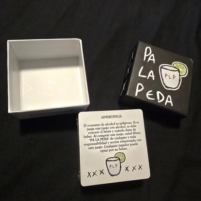 Playing cards with 'PA LA PEDA' branding on a black background