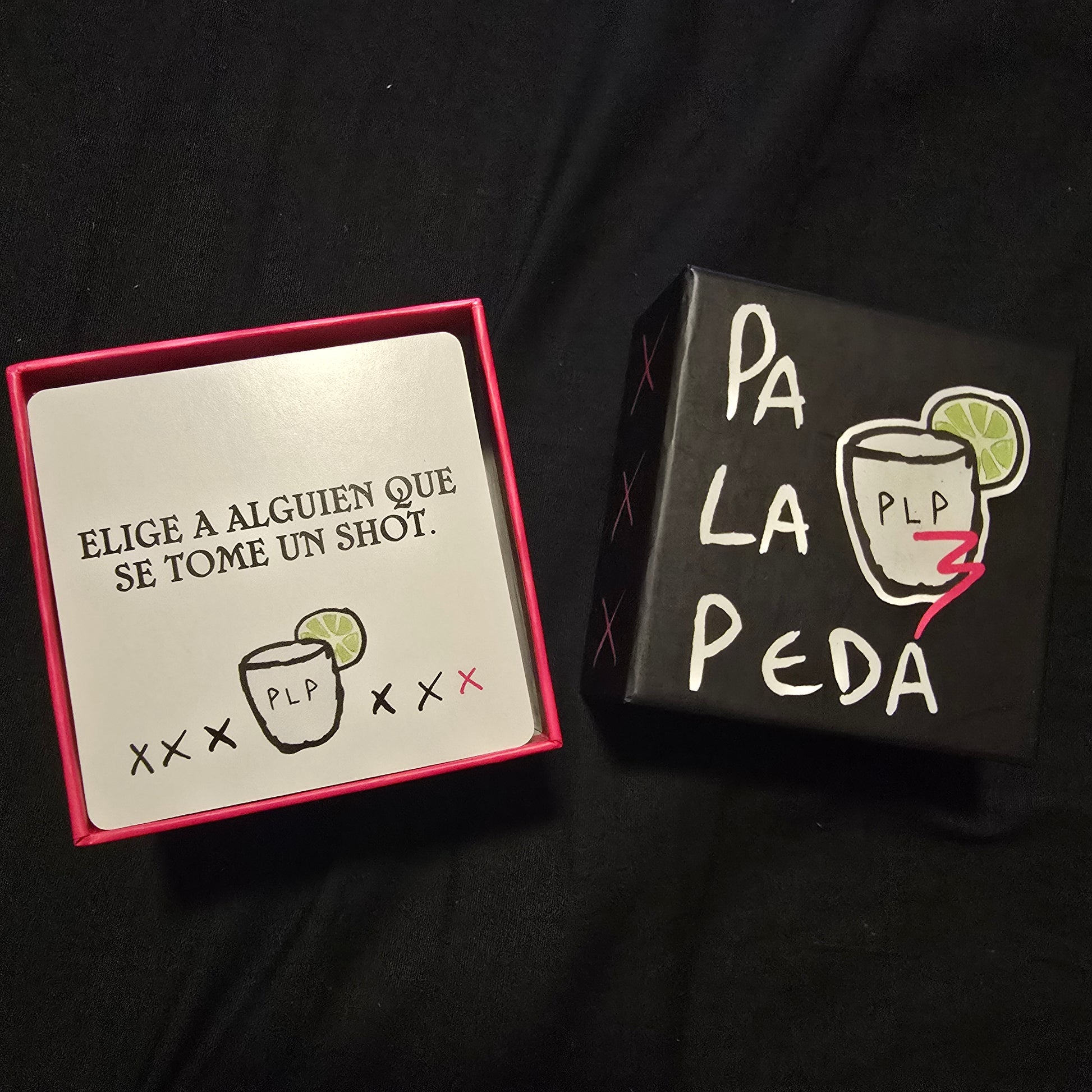 Black box with 'Pa La Peda' branding on a black background with card out