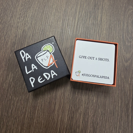 Two small boxes on a wooden surface, one with text and the other with a graphic design.