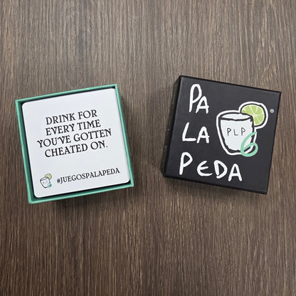 Two card games on a wooden surface, one with 'Pa La Peda' branding.
